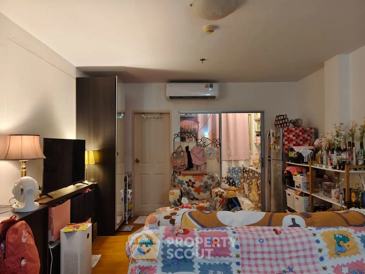 Cozy living room with colorful decor and air conditioning