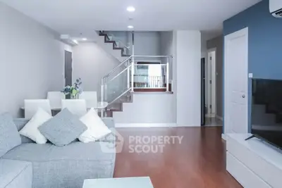 Spacious modern living room with elegant staircase and stylish decor