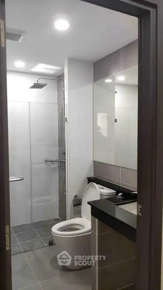 Modern bathroom with sleek fixtures and glass shower enclosure