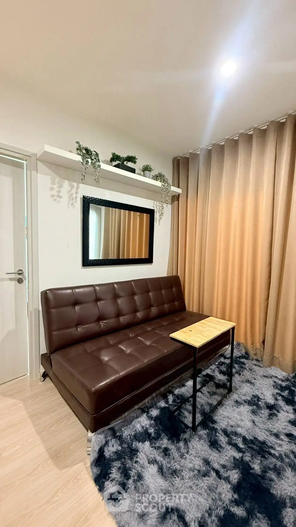 Stylish living room with brown leather sofa and modern decor