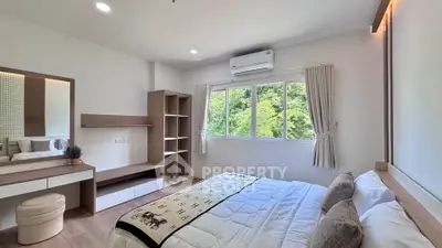 Bright and modern bedroom with large window and stylish decor