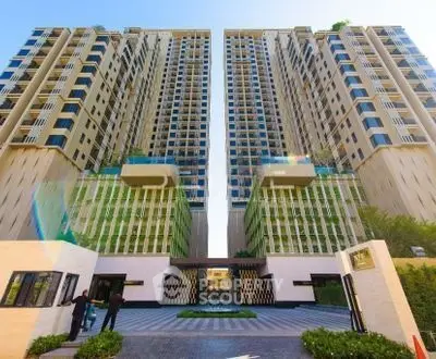 Stunning modern high-rise residential building with elegant entrance and lush landscaping.