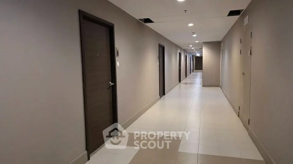 Modern apartment corridor with sleek design and multiple doors, ideal for urban living.