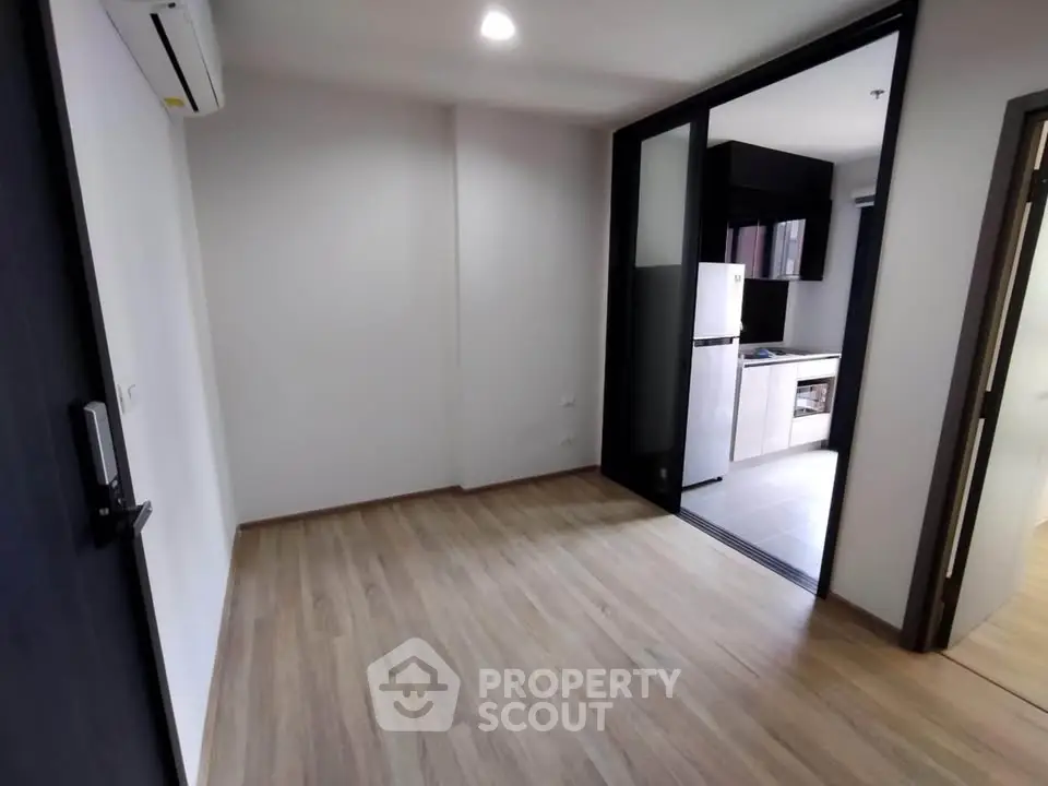 Modern apartment interior with sleek kitchen and wooden flooring, perfect for urban living.