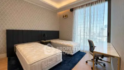 Luxurious bedroom with twin beds and city view, featuring elegant decor and floor-to-ceiling windows.