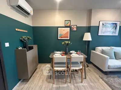 Stylish modern living room with dining area, featuring elegant decor and cozy seating.