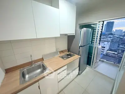 Modern kitchen with sleek cabinets and city view balcony