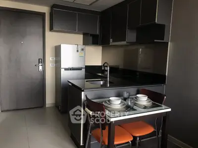 Modern compact kitchen with sleek cabinets and dining area in stylish apartment