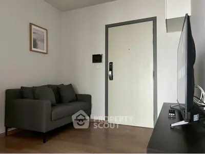 Cozy living room with modern sofa and wall art, perfect for relaxation.