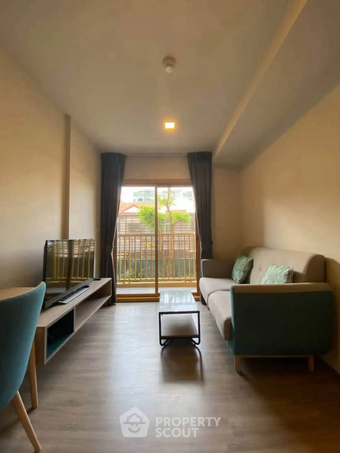 Cozy living room with modern furniture and balcony view in a stylish apartment.