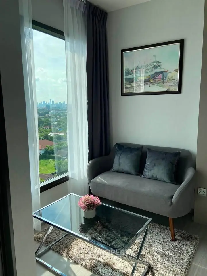 Chic living room with stunning city view, modern sofa, and elegant decor in a high-rise apartment.