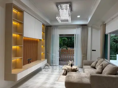 Luxurious living room with elegant lighting and spacious design, featuring a plush sofa and modern decor.