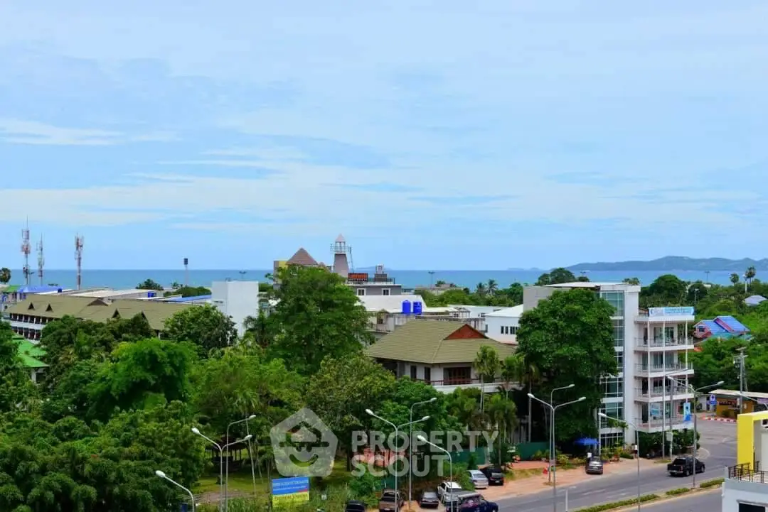 Scenic coastal view with lush greenery and urban landscape, perfect for real estate investment.