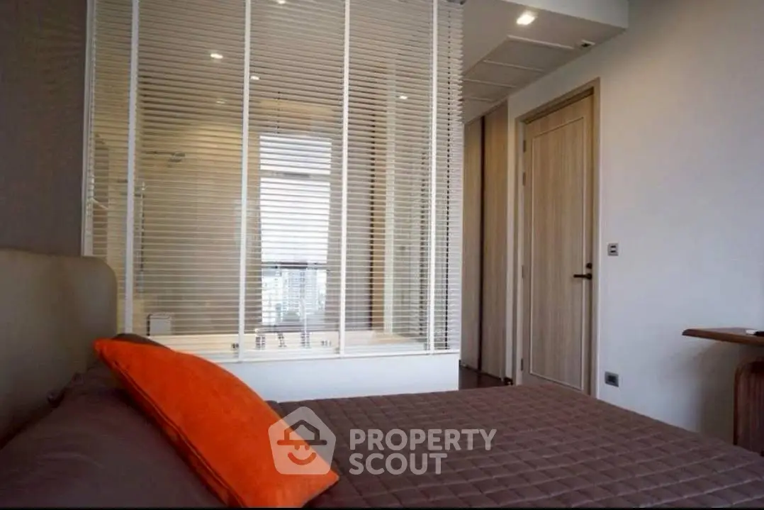 Modern bedroom with stylish decor and large window view