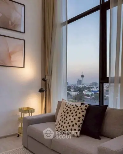 Stylish living room with city view, modern decor, and cozy seating area.