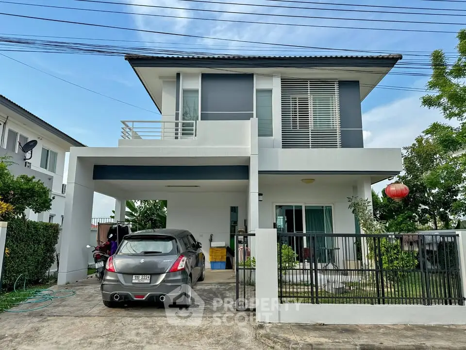 Modern two-story house with carport and sleek design in a suburban neighborhood.