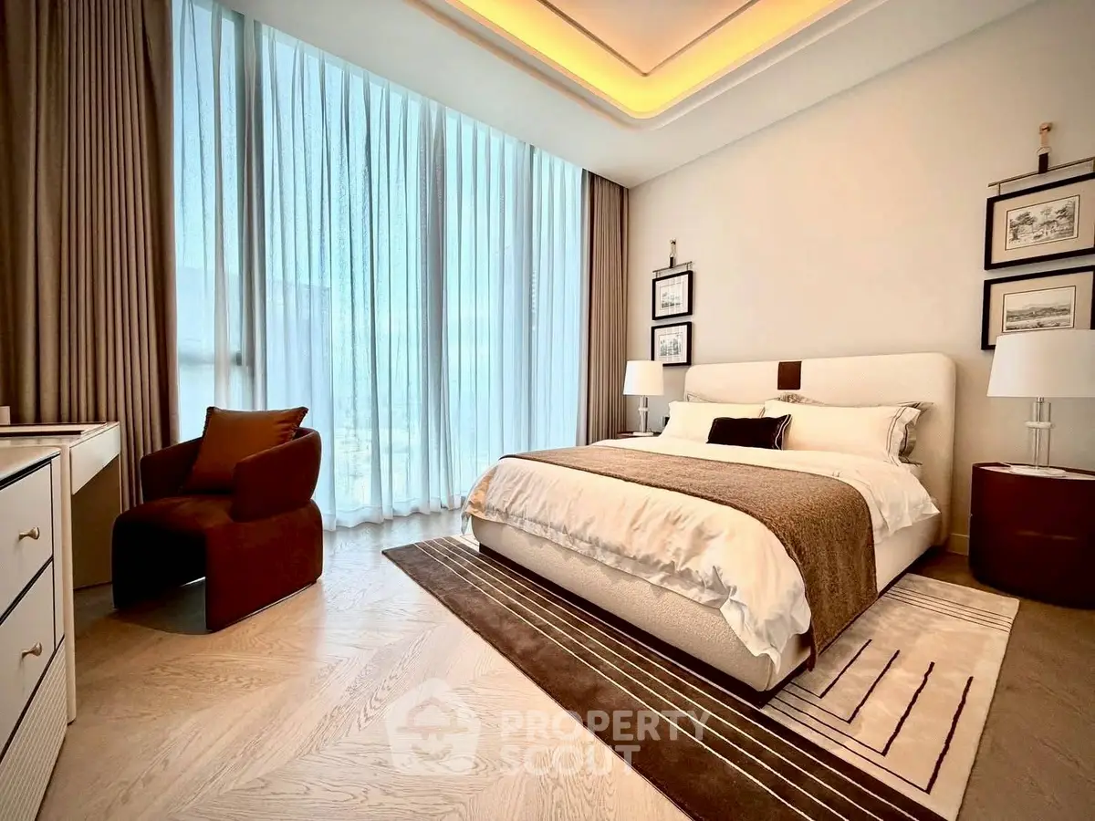 Luxurious bedroom with elegant decor and large window, featuring a cozy bed and stylish furnishings.
