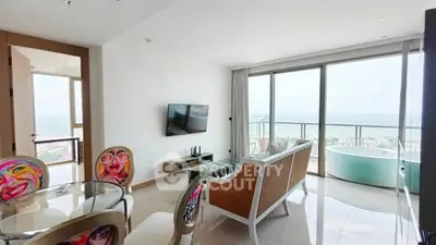 Spacious living room with ocean view and stylish decor in modern apartment.