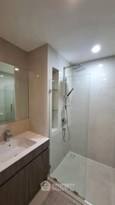 Modern bathroom with glass shower and sleek vanity unit