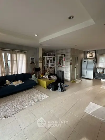 Spacious living room with modern decor and large windows for natural light.