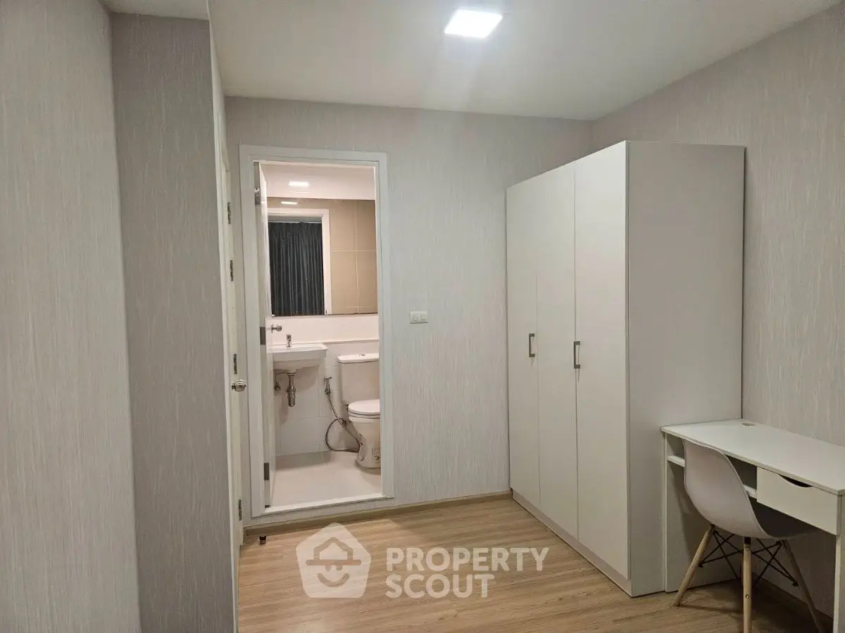 Modern minimalist bedroom with ensuite bathroom and study area