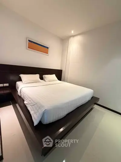 Spacious modern bedroom with elegant platform bed and minimalist decor