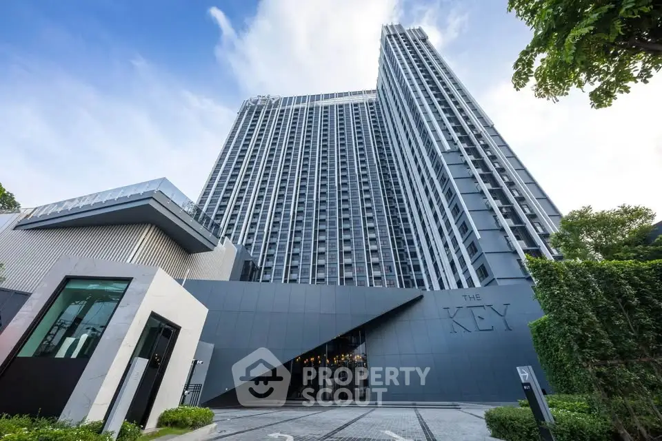 Stunning modern high-rise building with sleek architecture and lush greenery, perfect for urban living.