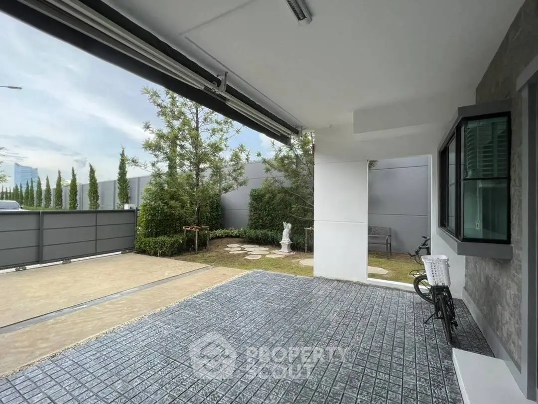 Modern home exterior with spacious driveway and lush garden view