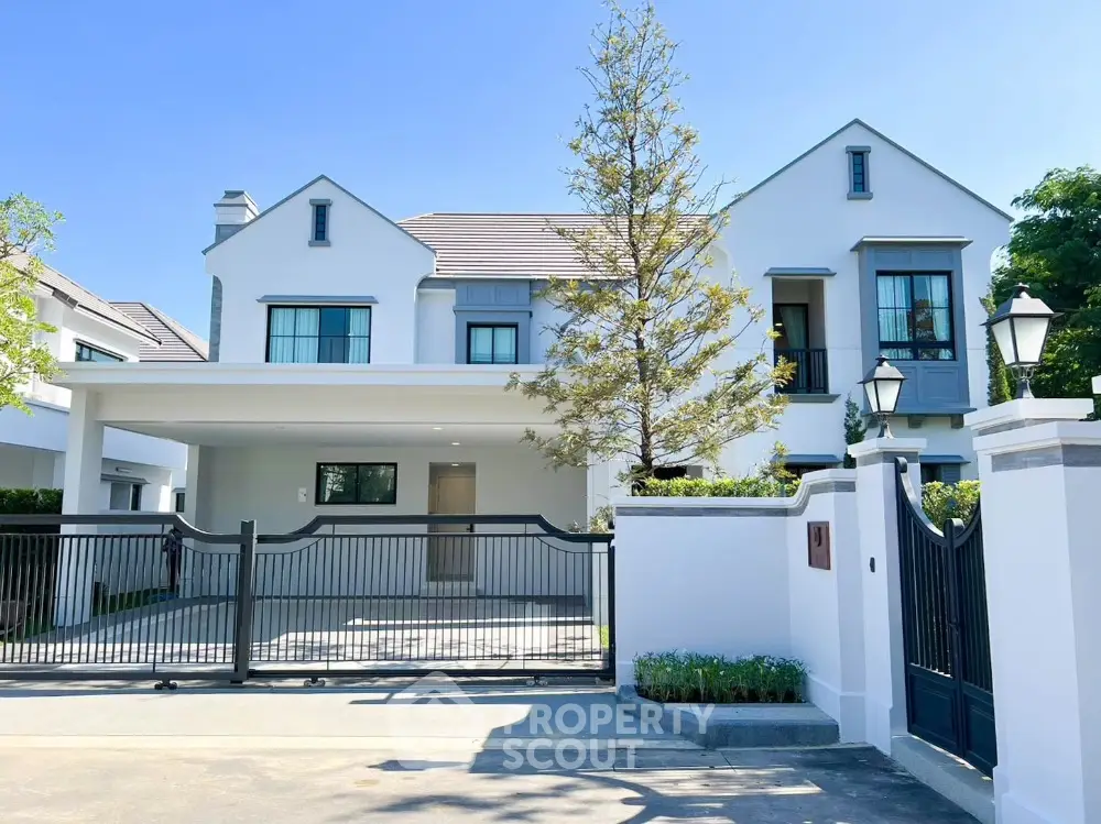 Stunning modern house with spacious driveway and elegant gated entrance, perfect for luxurious living.