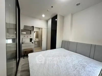 Modern bedroom with sleek design and ensuite bathroom in a stylish apartment.