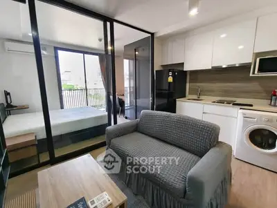 Modern studio apartment with open layout, featuring a cozy living area, compact kitchen, and bedroom with balcony access.