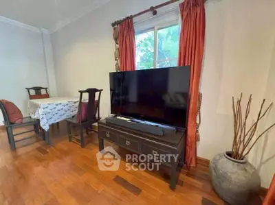 Charming living room with elegant wooden flooring and stylish furniture, perfect for cozy gatherings.