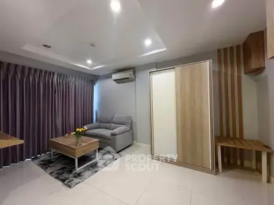 Modern living room with cozy sofa and stylish decor in a contemporary apartment.