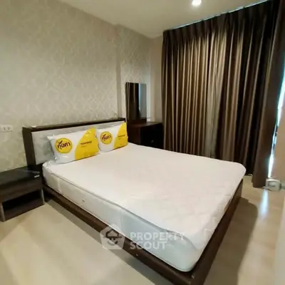 Spacious bedroom with elegant decor and large window for natural light.