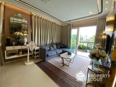 Luxurious living room with elegant decor and large windows overlooking a lush garden.