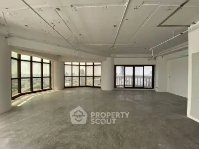 Spacious corner unit with panoramic city views and large windows in a modern high-rise building.