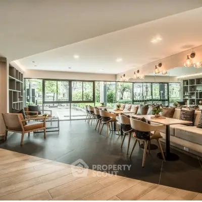 Spacious modern living room with elegant seating and large windows overlooking a lush garden.