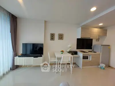 Modern open-plan living room with sleek kitchen and dining area