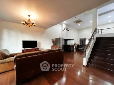 Spacious open-plan living room with elegant wooden flooring and modern furniture