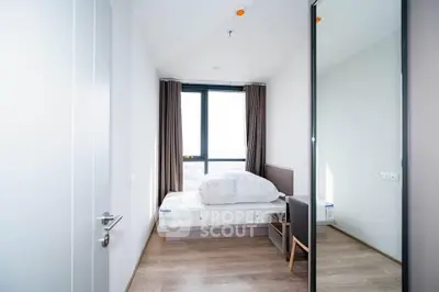 Bright and modern bedroom with large window and minimalist decor