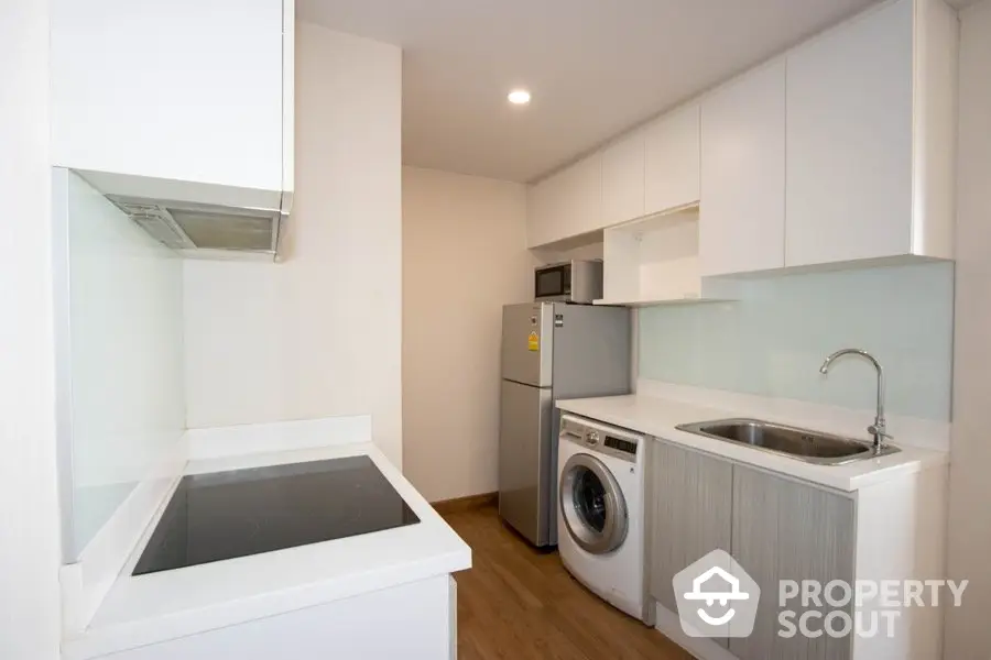 Modern kitchen with sleek appliances and ample storage space