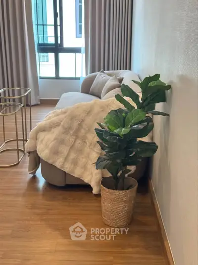 Stylish living room with cozy sofa, elegant decor, and natural light for modern comfort.