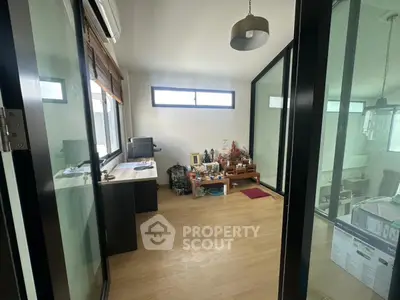 Modern study room with glass walls and wooden flooring
