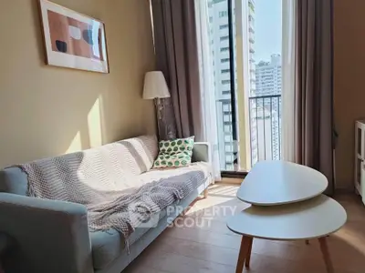 Chic living room with modern decor and city view balcony in urban apartment.