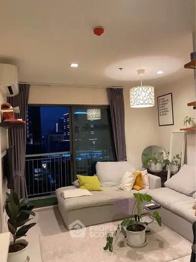 Cozy living room with modern decor and city view, featuring a comfortable sofa and stylish lighting.