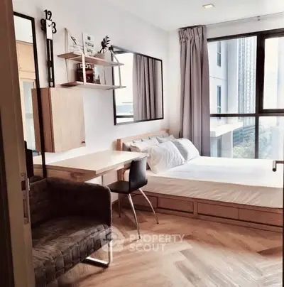 Modern bedroom with large window, stylish furniture, and city view.