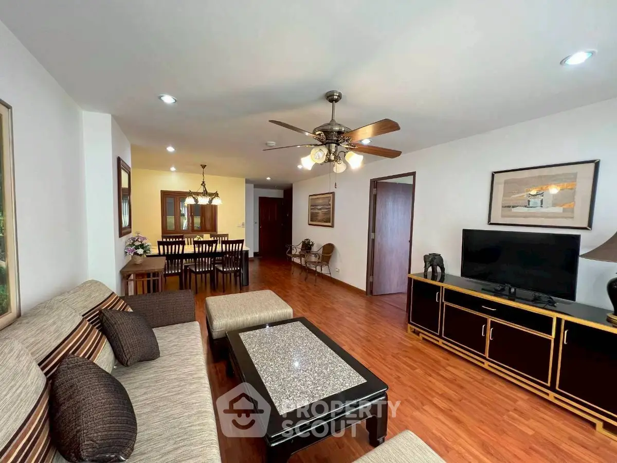 Spacious living room with elegant decor and dining area, perfect for family gatherings.