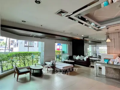 Spacious modern living room with stylish furniture and large windows offering natural light.