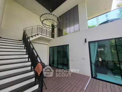 Modern duplex interior with high ceilings and stylish staircase