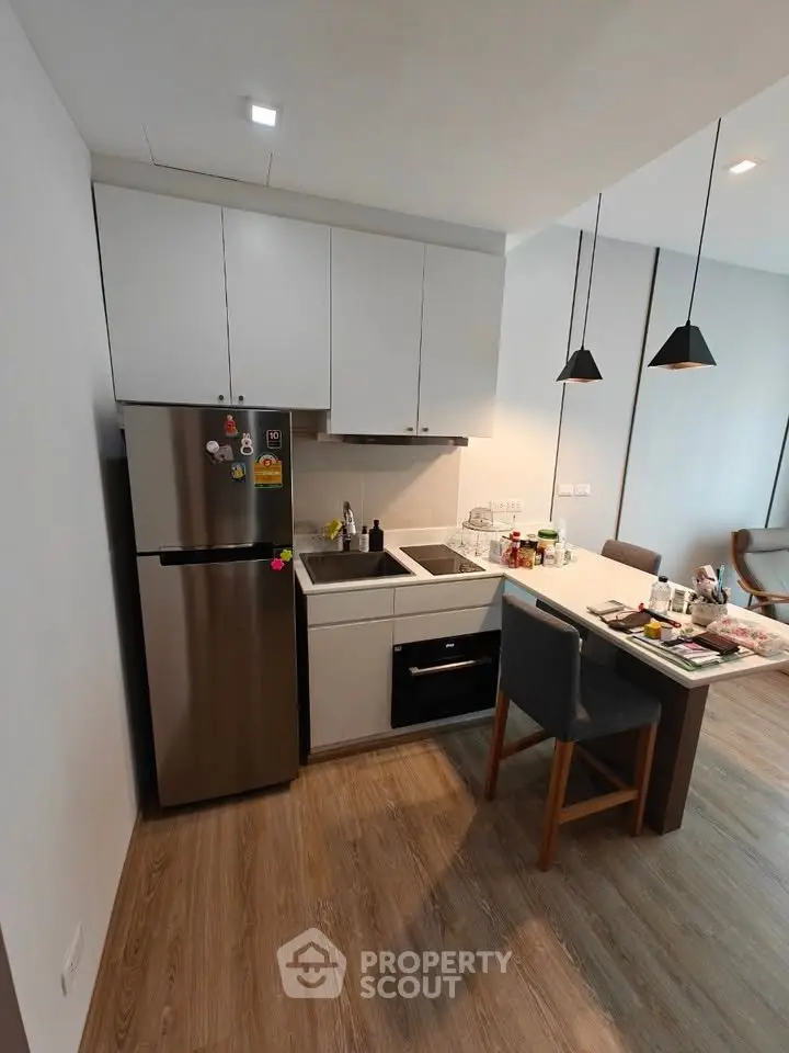 Modern kitchen with sleek appliances and open layout in stylish apartment